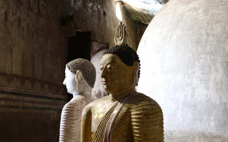 Statues and decorations inside the rock temple in Sri Lanka.